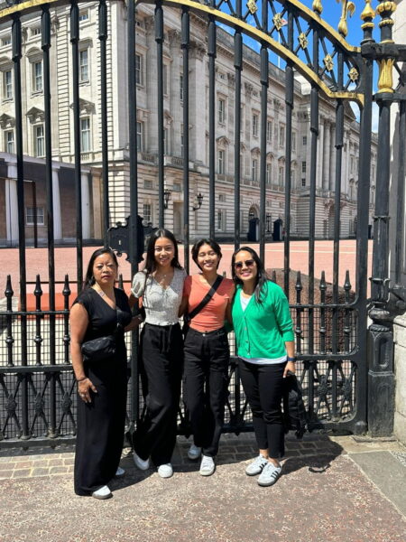 Group of tourists standing in front of Buckingham Palace gates, one of the best places to visit near London