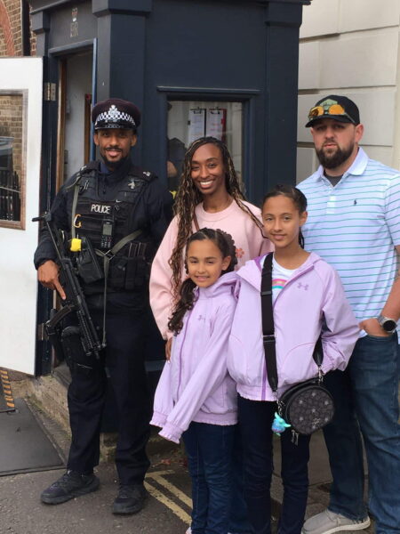 London 1 Day Itinerary featuring family posing with armed police officer outside building during sightseeing tour