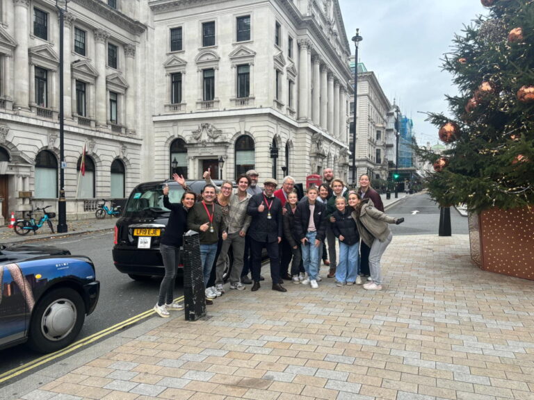 Group enjoying a London sightseeing taxi tour near iconic landmarks, a must-see activity in London.