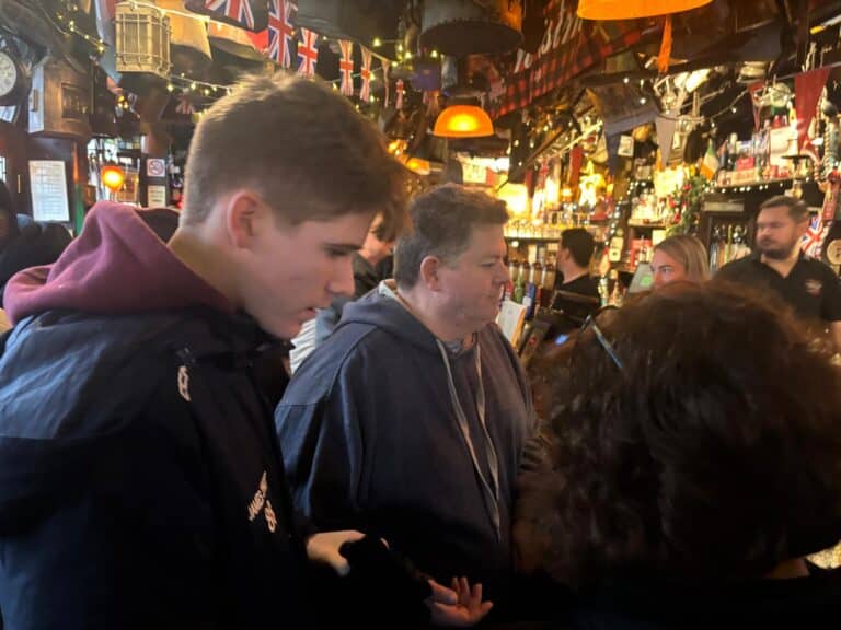 Group enjoying Tours In London UK inside a traditional British pub