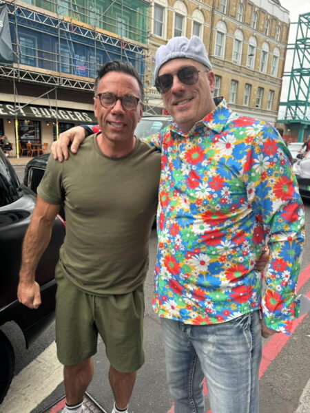 Visitors enjoying Sightseeing In London For One Day with London Sightseeing Taxi Tours, posing on a vibrant London street with historic buildings in the background