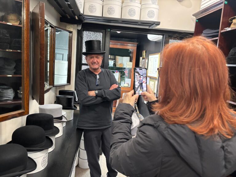 Must see in London 1 day tour includes visit to traditional hat shop with man in top hat posing for tourist photo