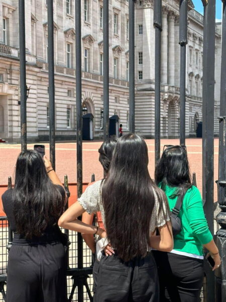 Visitors looking through palace gates during London Eye Get Your Guide sightseeing tour experience in London