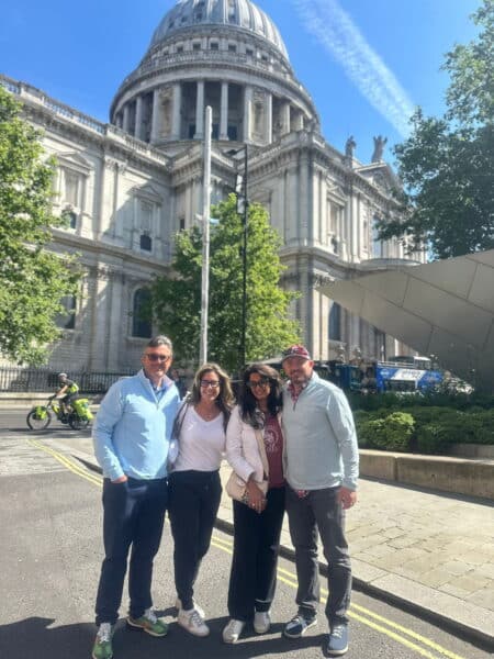 Happy tourists enjoying Guided Day Tours From London with St. Paul's Cathedral iconic dome in the background