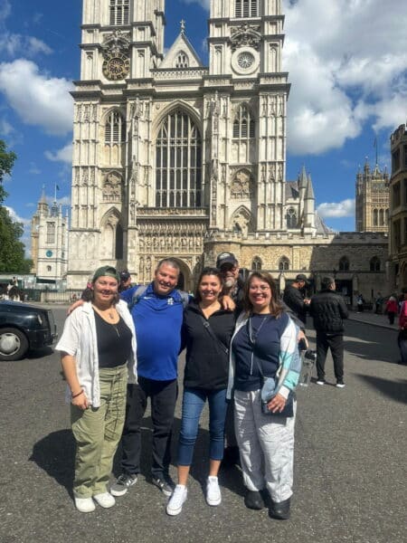 Group enjoying London Must See Top 10 sightseeing taxi tour in front of Westminster Abbey