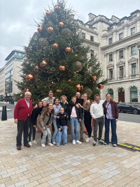 Free Walking Tour City Of London group photo in front of a decorated Christmas tree with historic London architecture in the background