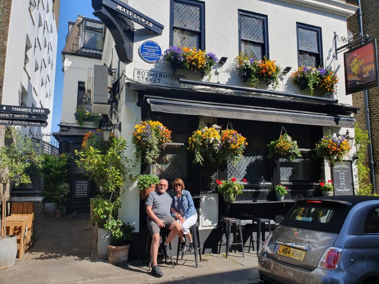 Tourist Spots in London UK visitors sitting outside the Mayflower pub on a sunny day