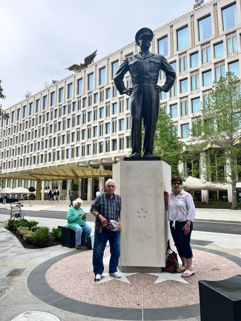 Visitors pose by Dwight D. Eisenhower statue during a 2 Day Trip In London sightseeing taxi tour