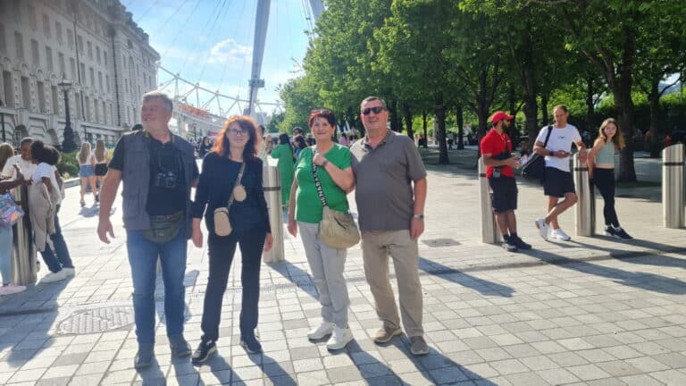 Group of tourists enjoying Old City London Walking Tour near famous London landmarks