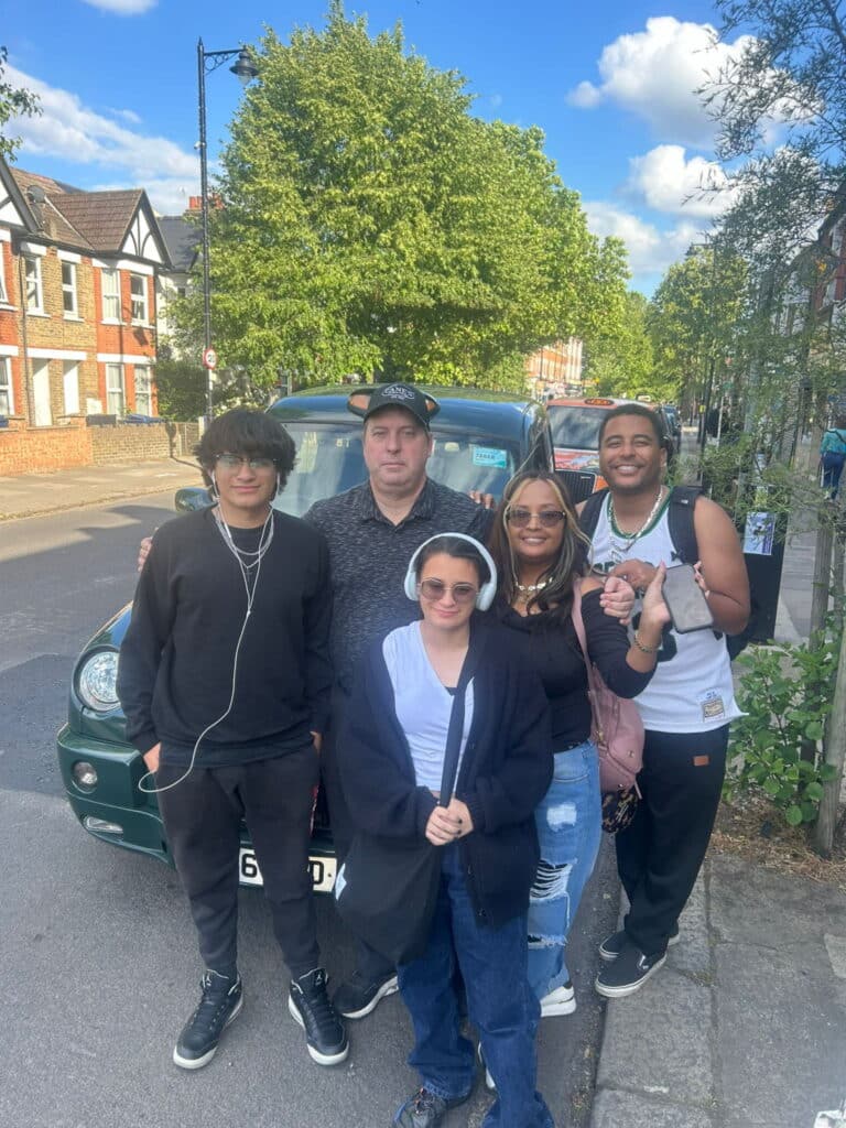 Group enjoying a Tourist Day In London via Sightseeing Taxi Tours on the street