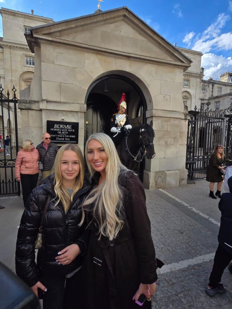 Photo of tourists enjoying a London taxi photo tour capturing stunning landmarks.