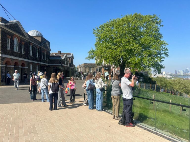 Group of tourists enjoying London sightseeing taxi tours at one of the most popular places to visit in London