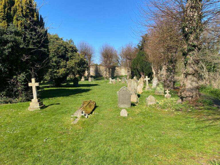 Most Popular Day Trips From London - Visitors enjoying a peaceful historic cemetery landscape with old gravestones and clear blue skies during a London taxi tour