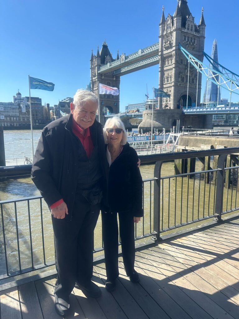 Couple enjoying Tower Bridge view on a tripadvisor london tours experience with London Sightseeing Taxi Tours, accessible for all including wheelchair users