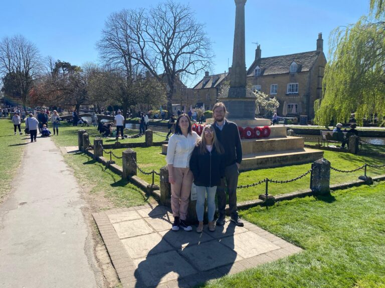 One day trip from London exploring scenic villages with London Sightseeing Taxi Tours, group enjoying war memorial and river walk