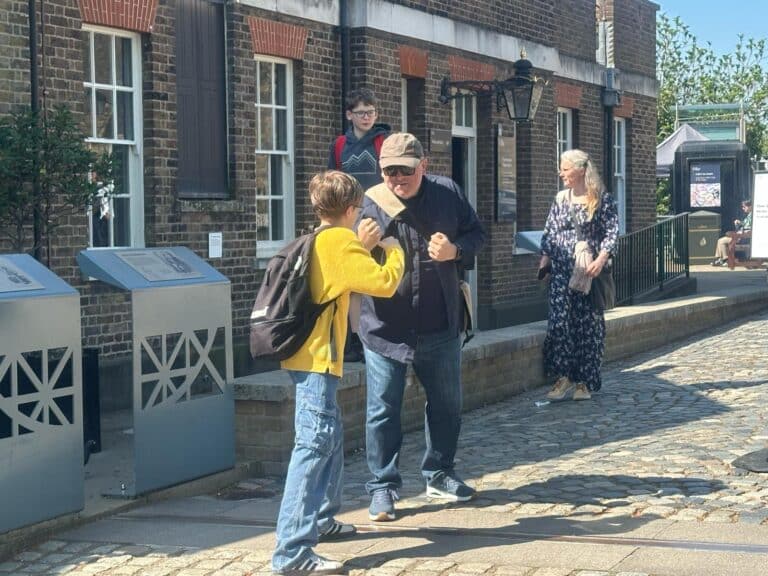 The tour guide engaging with visitors during a London sightseeing taxi tours experience, showcasing iconic city landmarks