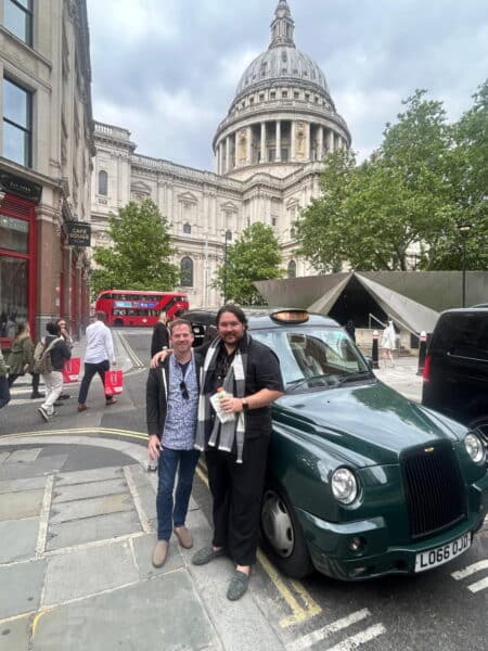 Best day tours from London featuring friends posing with wheelchair-accessible black cab taxi in front of iconic St. Paul's Cathedral