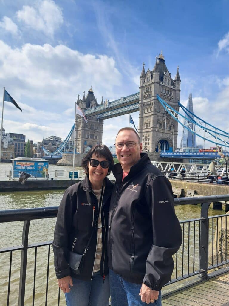 Visitors enjoying the best tours from London with London Sightseeing Taxi Tours, posing in front of the famous Tower Bridge for a memorable sightseeing experience
