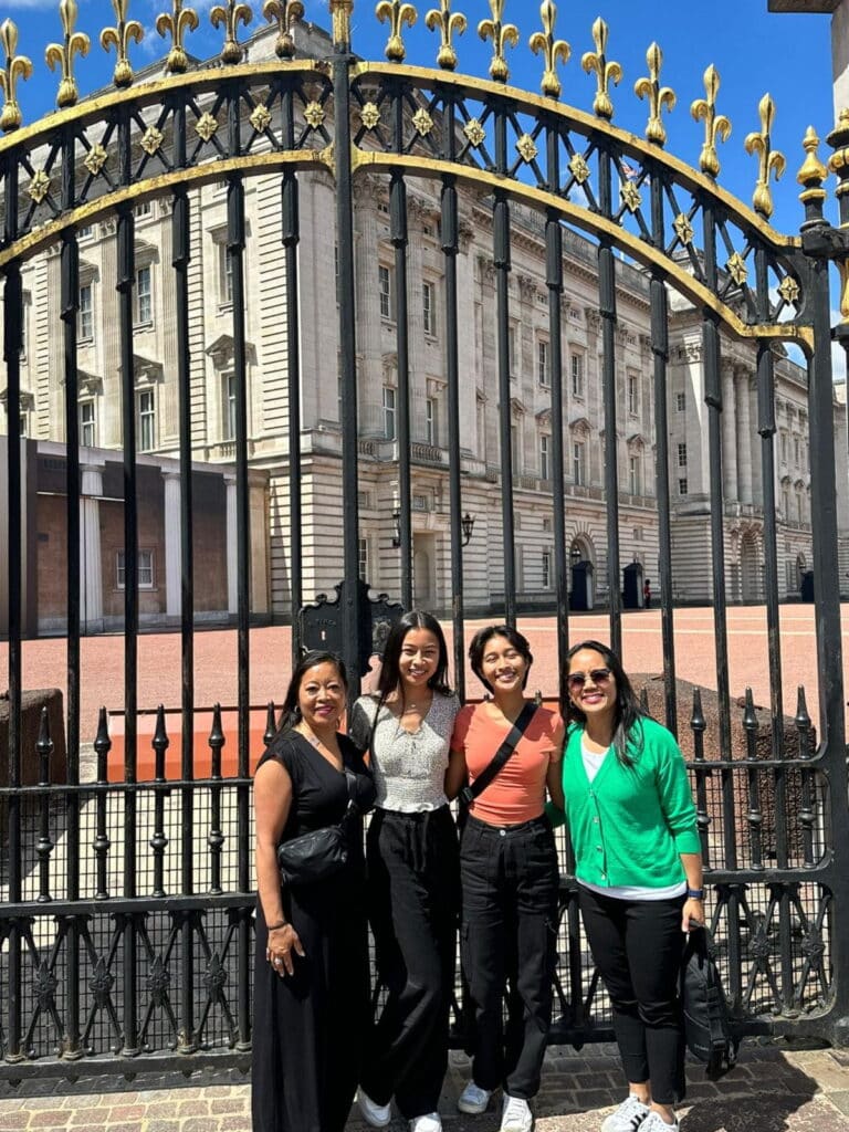 Group of visitors enjoying british museum private tours in London with sightseeing taxi tours, posing at ornate gates