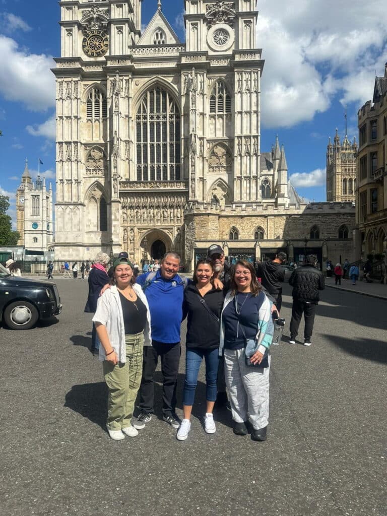 Stonehenge trip from London - Family group posing in front of historic Westminster Abbey during a private London sightseeing taxi tour experience