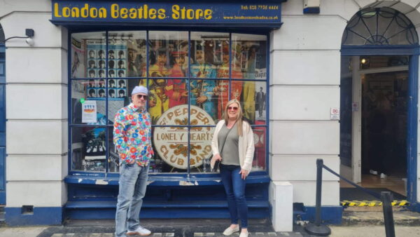 Visitors outside the London Beatles Store on tours to london with London Sightseeing Taxi Tours