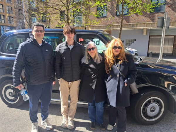 Group of visitors enjoying a tour with the best london tour companies in a wheelchair-accessible taxi