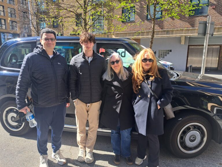 Group of visitors enjoying a tour with the best london tour companies in a wheelchair-accessible taxi