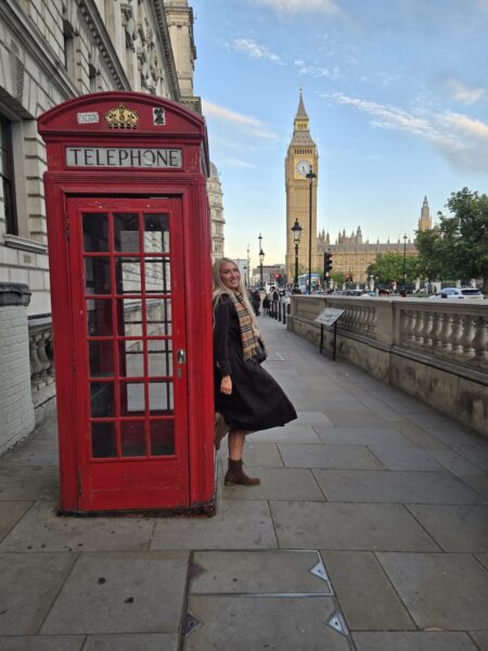 Tourist posing with red phone booth and Big Ben during small group tours London sightseeing experience