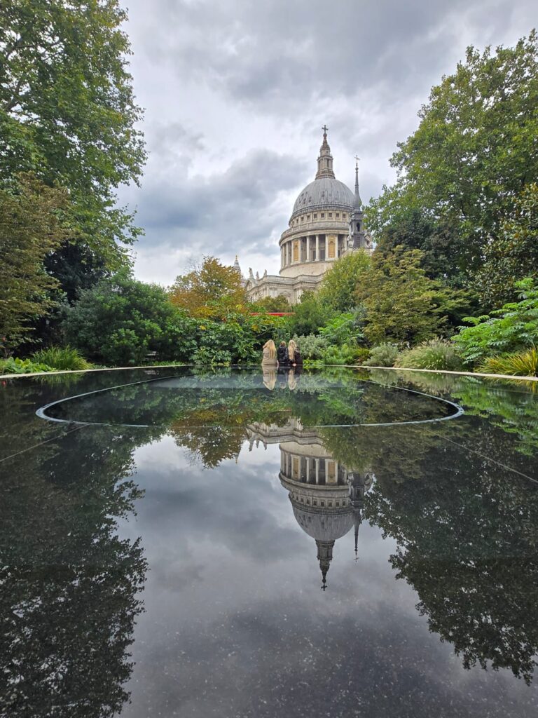 Stonehenge tours from London featuring St. Paul's Cathedral reflection in serene gardens, perfect for sightseeing taxi tours