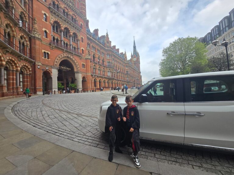 Get My Guide to magical London tours: Fans in Harry Potter costumes outside historic St. Pancras station with luxury taxi for sightseeing experiences