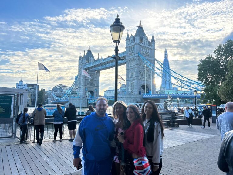 Get your tour guide for an unforgettable London sightseeing experience at Tower Bridge, featuring a family enjoying the views with accessible taxi tours for up to six people