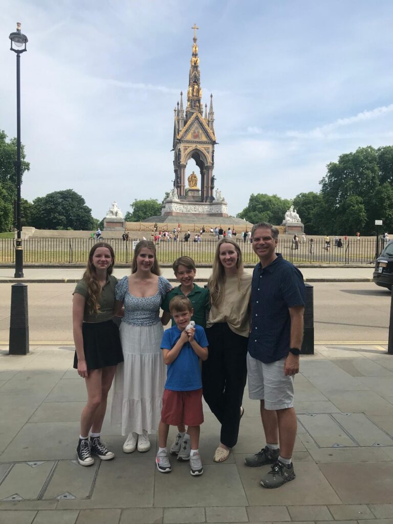 Family group on London walks tours sightseeing at the iconic Albert Memorial, experiencing guided walking tours of London's landmarks with London Sightseeing Taxi Tours