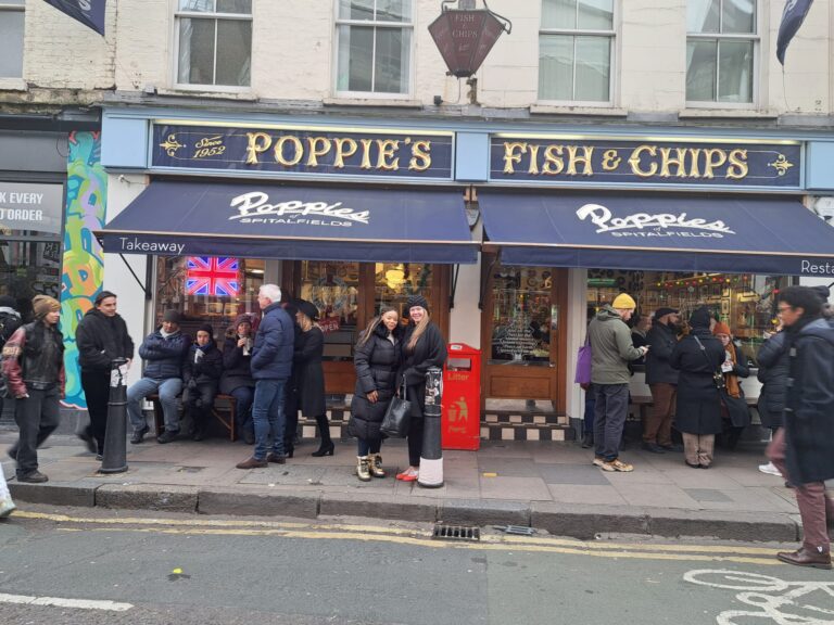 Visitors enjoying Poppie's Fish & Chips in London during their England trips with sightseeing taxi tours