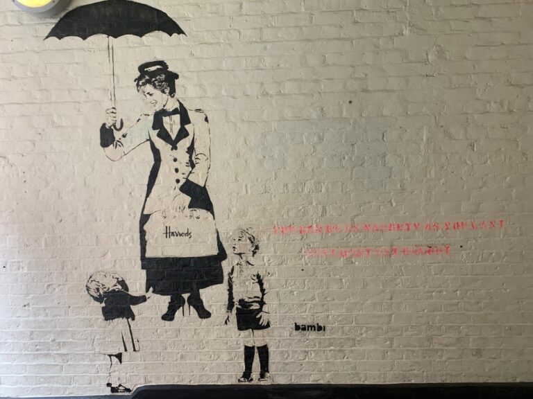 Discover the whimsical Mary Poppins street art mural during VIP tours in London, featuring the flying nanny with children and umbrella against a brick wall backdrop