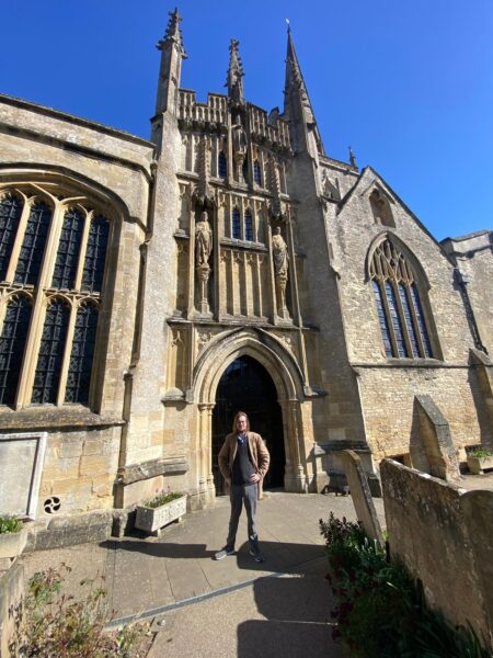 Visitors experiencing the best London night bus tour at a historic Gothic cathedral in London