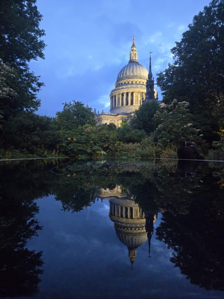 Travel by locals: St. Paul's Cathedral reflection in serene waters during London sightseeing taxi tours