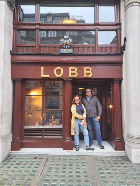 Couple enjoying Westminster tour with London Sightseeing Taxi Tours outside historic John Lobb shoe shop in London