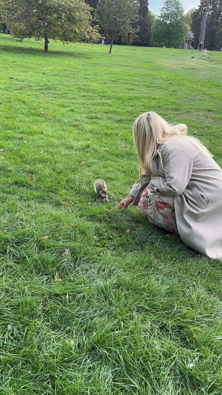 Visitors enjoying a london one day tour package in a scenic London park, pet-friendly experience with London Sightseeing Taxi Tours accommodating up to six people including wheelchair accessible vehicles