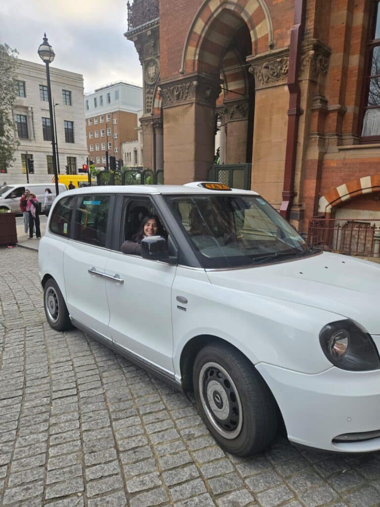 Group experiencing the best bus tours in London with a glass-roofed taxi