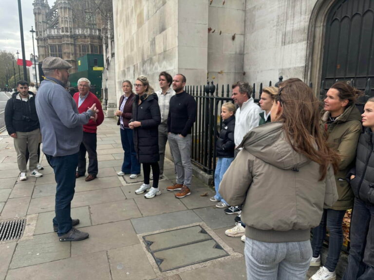 Tourists on a Harry Potter walk in London with a black taxi