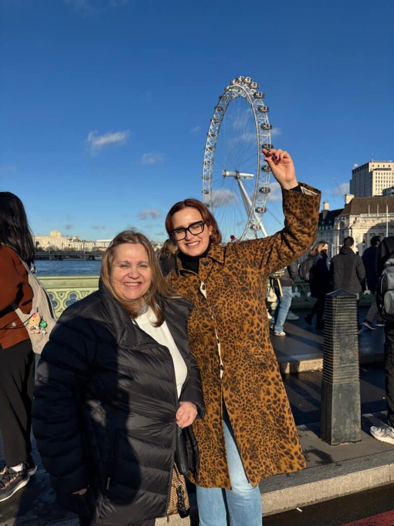Tourists enjoying a London Christmas taxi sightseeing tour in a black cab