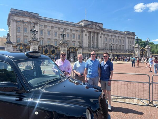 Group enjoying London day tour in a taxi with scenic views