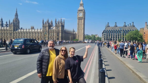 Tour guide in London showing tourists famous landmarks near Tower of London