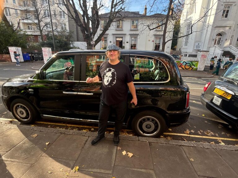 Black taxi in London decorated with Christmas lights for a 4-hour tour