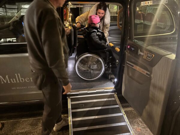 Group enjoying a London sightseeing taxi tour from a spacious coach