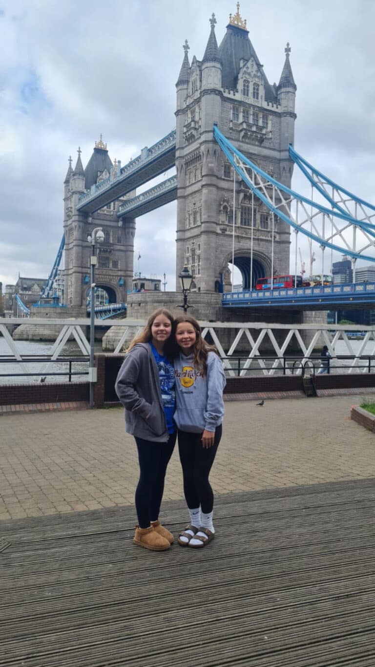 Group enjoying a London sightseeing tour in a black taxi