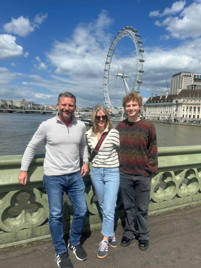 Tour guide showing Westminster to visitors in a London taxi